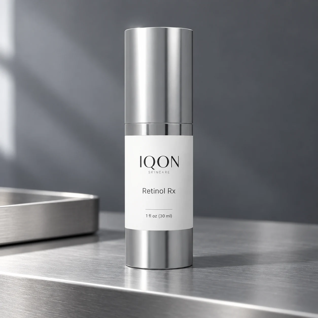 IQON Retinol Rx on brushed aluminum in quiet evening light